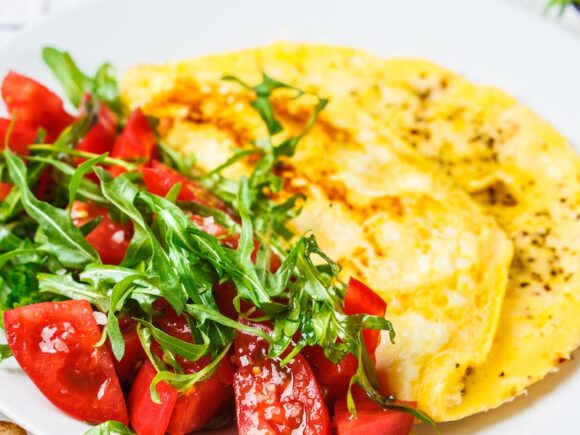 Cheesy omelet with tomato salad.