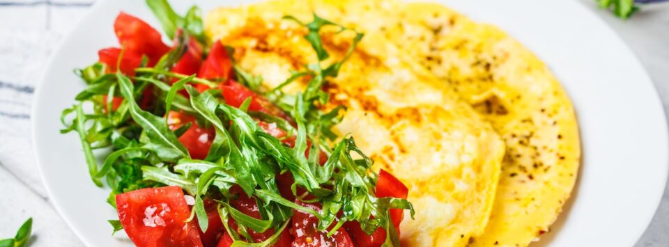 Cheesy omelet with tomato salad.