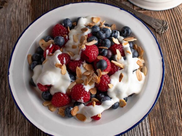 Yogurt with berries and roasted almonds, keto-friendly.