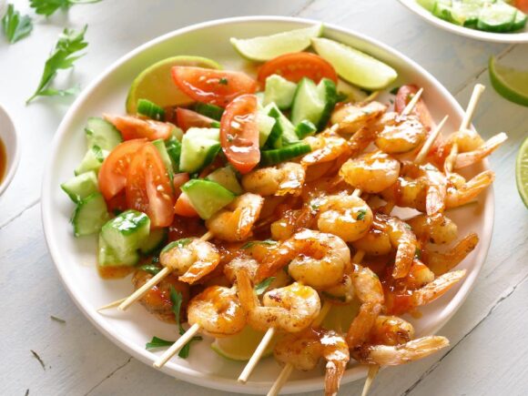 Shrimp skewers with vegetable salad.