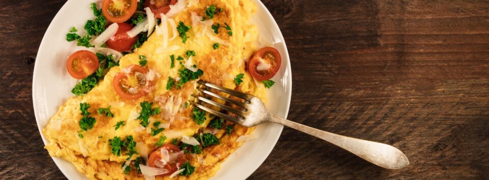 Keto omelet with parmesan and tomatoes.
